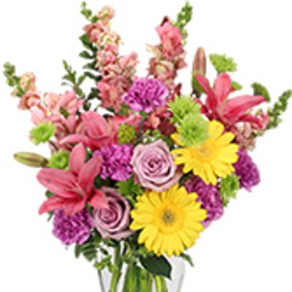 Mixed pink and yellow flowers in a clear glass vase