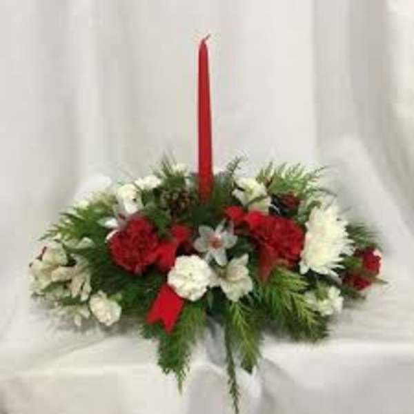 Red and white floral centerpiece with a tall red taper candle