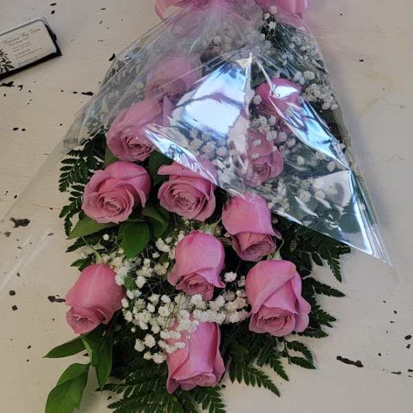 Pink rose bouquet wrapped in clear plastic with a pink bow