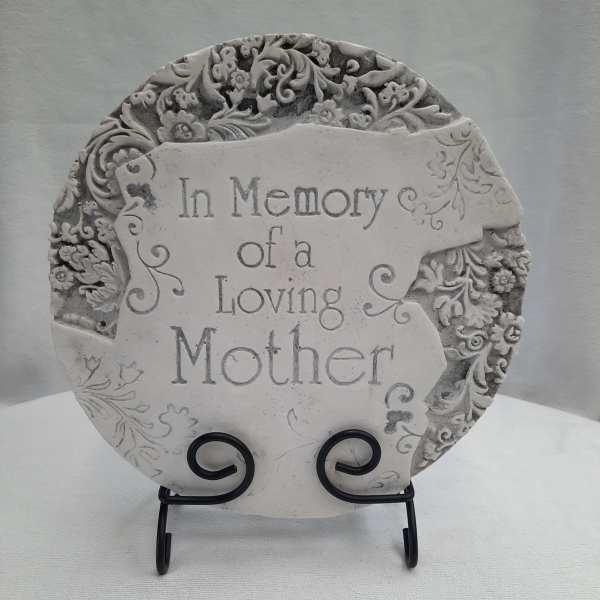 Decorative memorial plaque reading "In Memory of a Loving Mother" on a stand