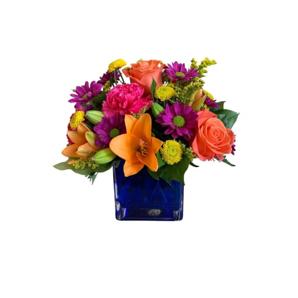 Colorful bouquet in a blue glass vase with roses, lilies, and daisies