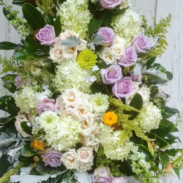 Large bouquet of lavender and white roses with pale hydrangeas