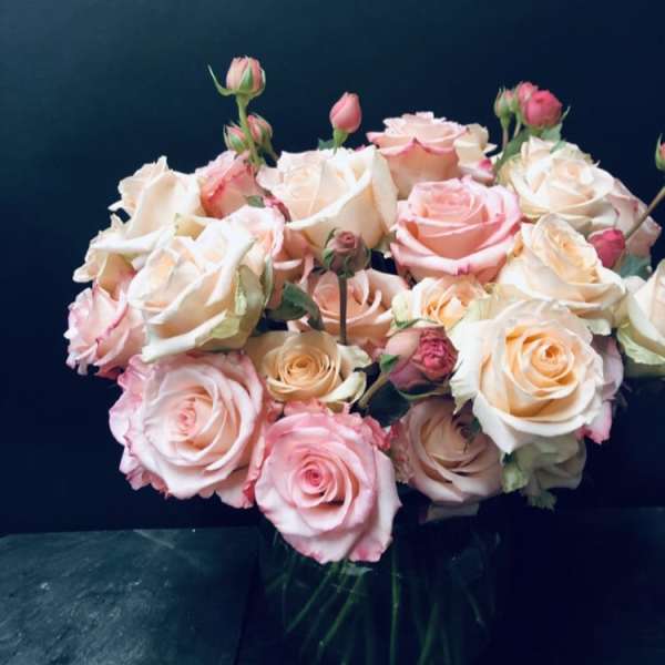 Bouquet of pink and cream roses in a glass vase
