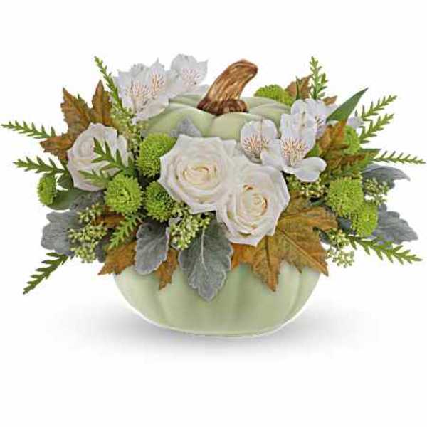 White roses and alstroemeria in a pale green pumpkin vase