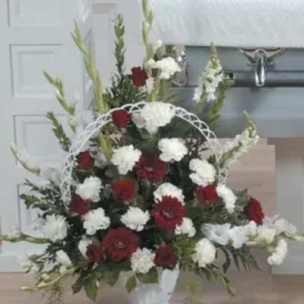 Red and white floral spray in a white easel frame