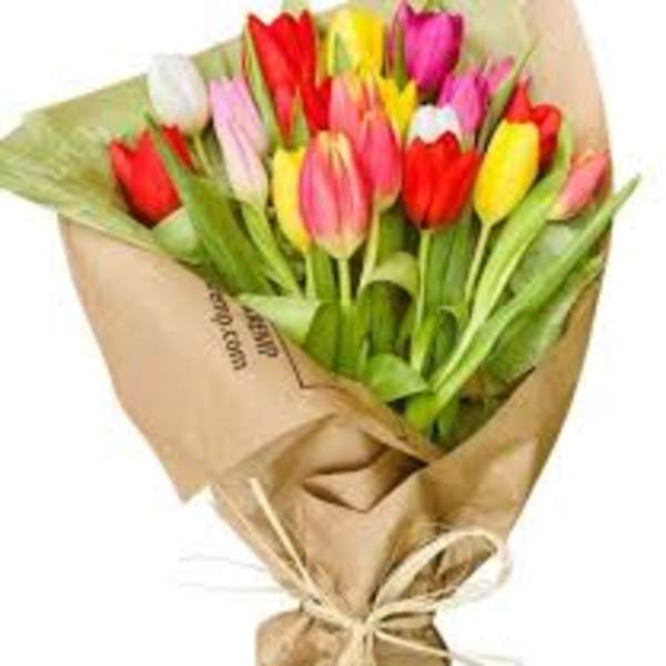 Bouquet of multicolored tulips wrapped in brown paper