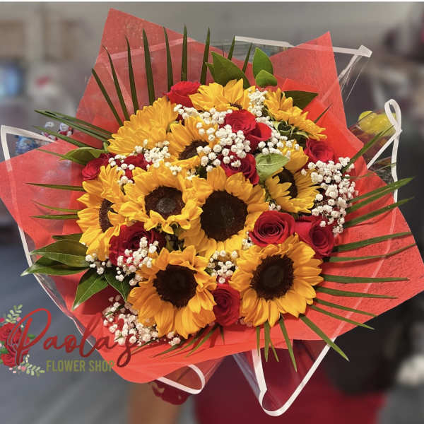 Bouquet of sunflowers and red roses wrapped in red paper