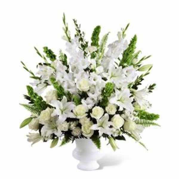 White floral arrangement in a white pedestal vase