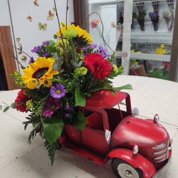 Flowers arranged in a red vintage truck container
