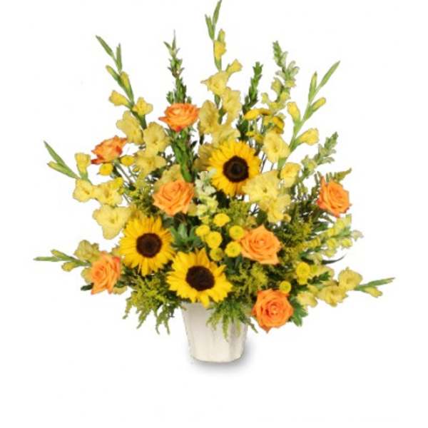 Tall yellow and orange flower arrangement with sunflowers and roses in a white container