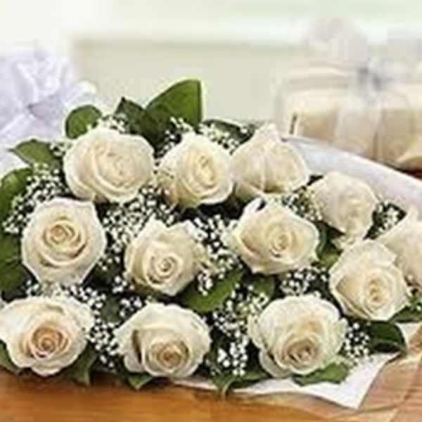 Bouquet of white roses with baby's breath wrapped in white paper