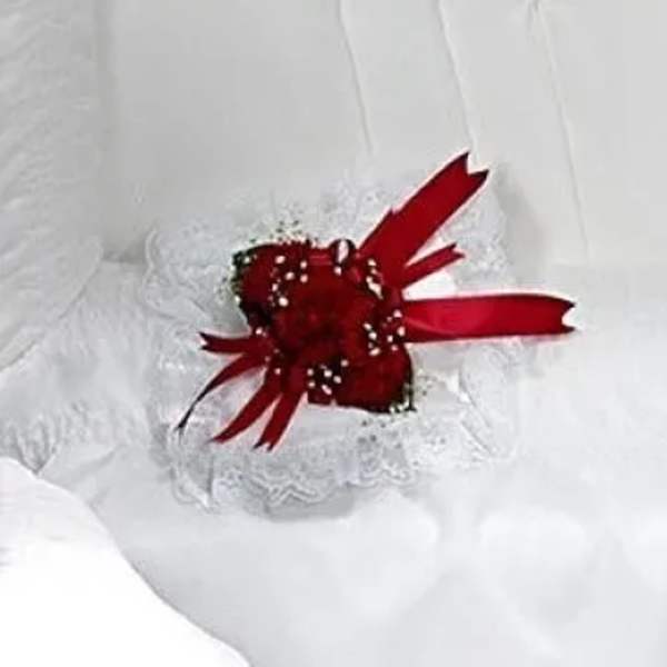 Red rose corsage with white lace and ribbon