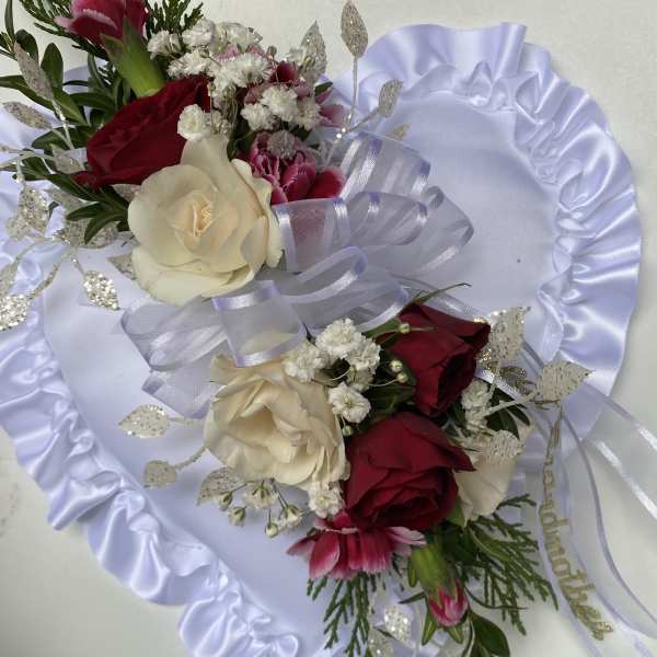 Two rose bouquets with white ribbon and satin backing