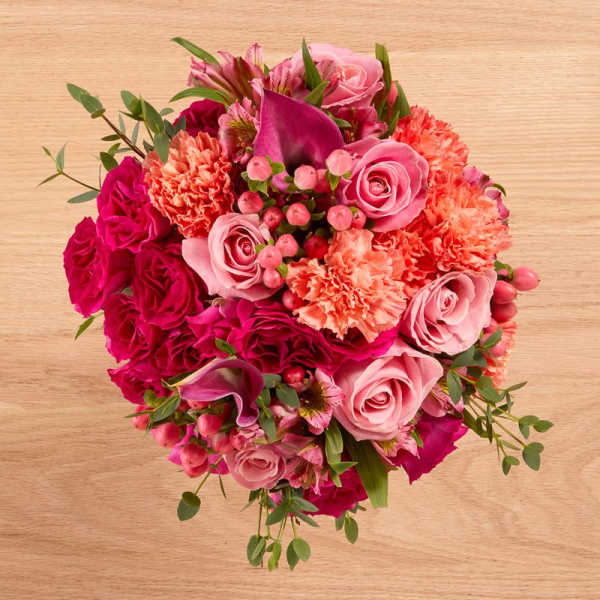 Pink and magenta bouquet with roses, carnations, and calla lilies