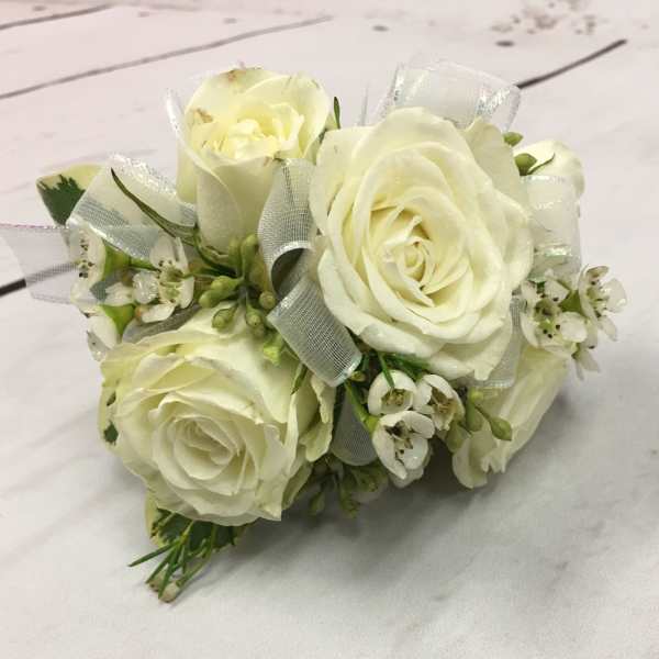 Small bouquet of white roses with ribbon accents