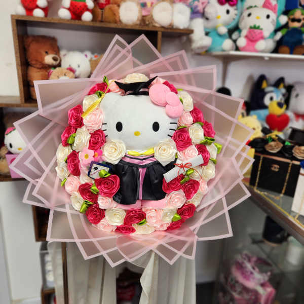 Hello Kitty plush bouquet surrounded by pink and white roses