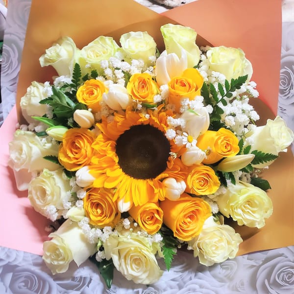 Bouquet of yellow roses, white tulips, and a sunflower