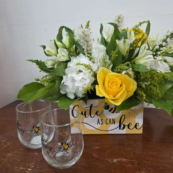 Yellow rose and white flowers in a decorative box with two bee-themed glasses