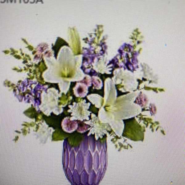 Purple and white floral arrangement in a purple vase