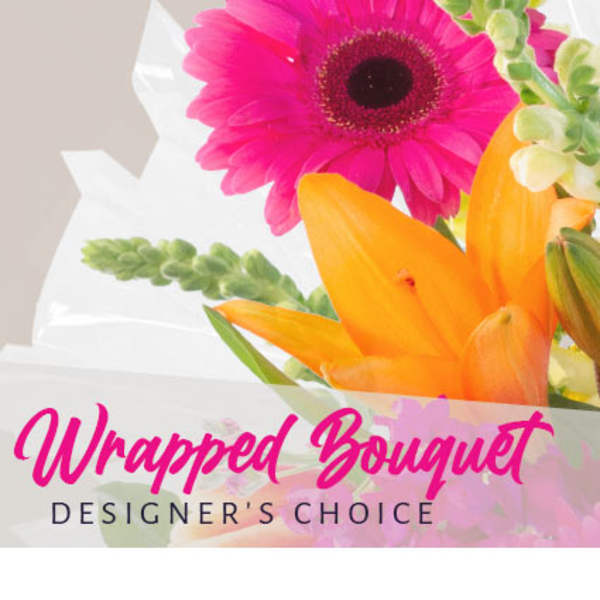 Bright pink gerbera and orange lily wrapped as a bouquet