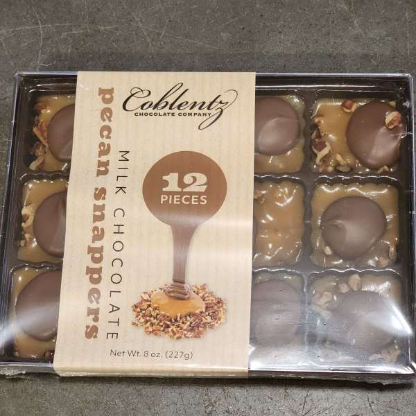 Box of pecan snapper milk chocolates in plastic tray