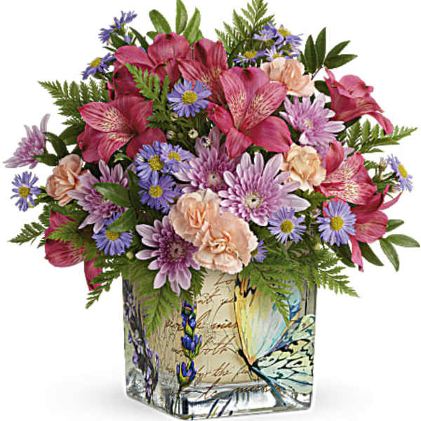 Mixed pink and purple bouquet in a decorative glass vase