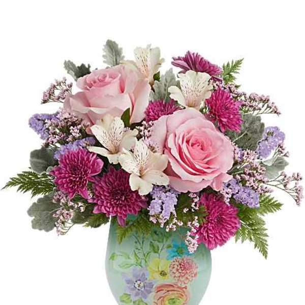 Pink roses and purple flowers arranged in a painted ceramic vase