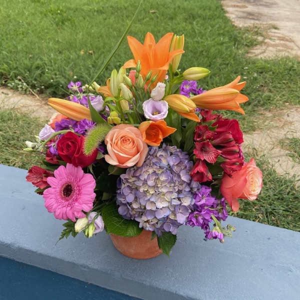 Colorful mixed bouquet in a small terracotta pot