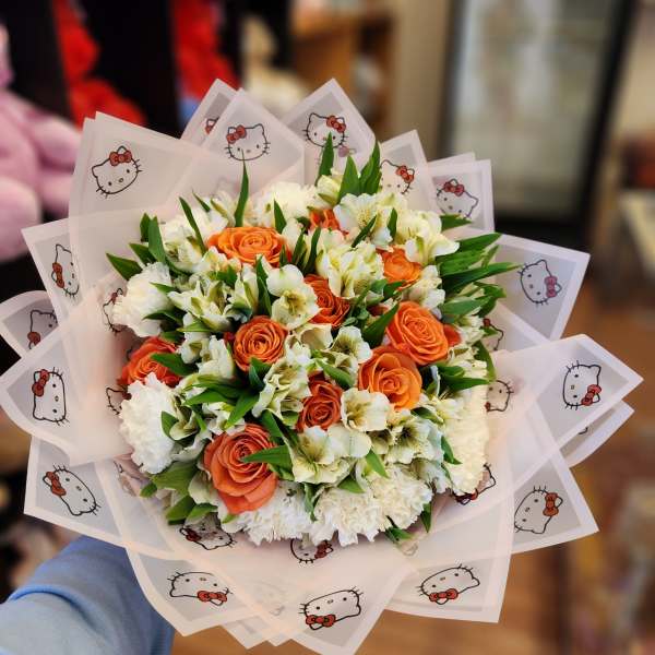 Orange roses and white flowers in Hello Kitty wrapping