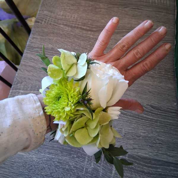 Small wrist corsage with white and green flowers