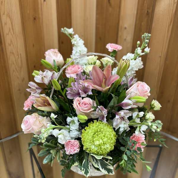 Basket of pink and white flowers with a lime-green bloom