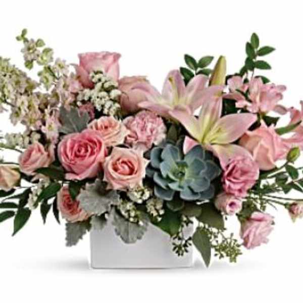 Pink roses and lilies in a white rectangular vase