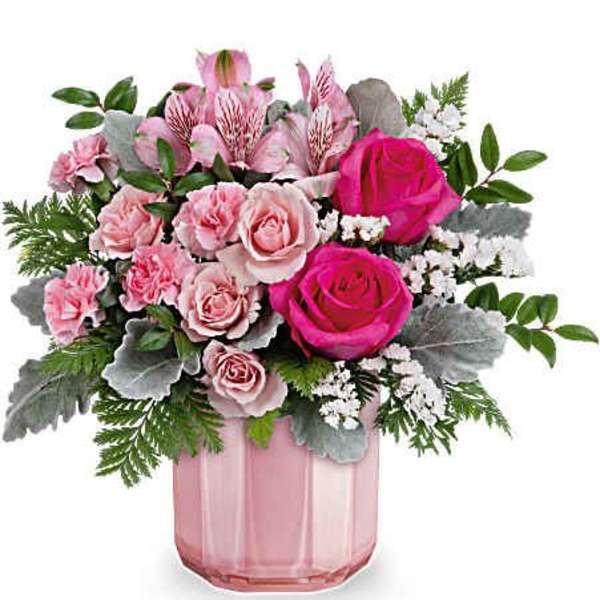 Pink roses and alstroemeria in a pink glass vase