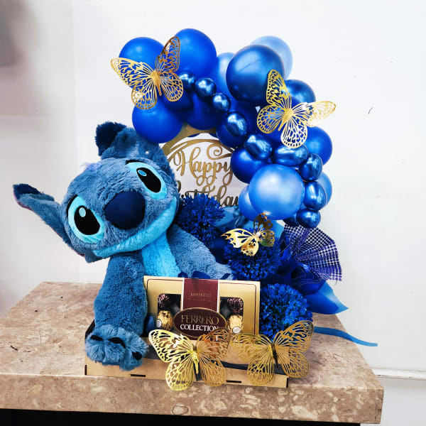 Blue plush toy with a balloon arch and chocolate box gift set