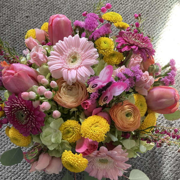 Mixed bouquet with pink gerberas, tulips, and yellow pompon flowers