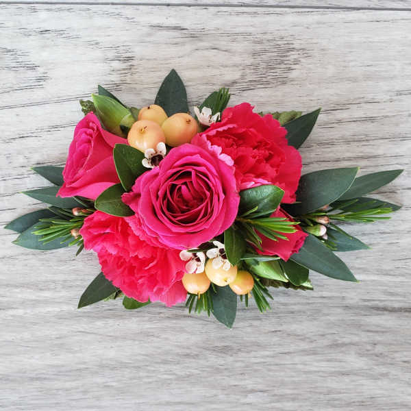 Pink rose and carnation bouquet with berries and greenery