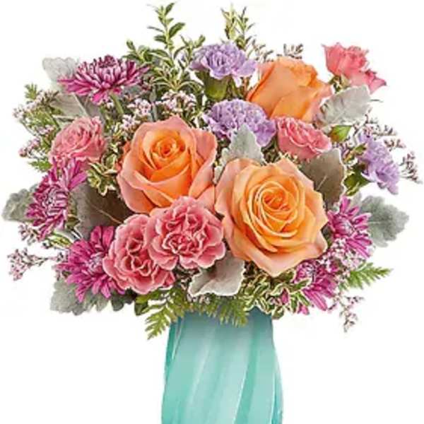 Bouquet of peach and pink roses in a turquoise vase