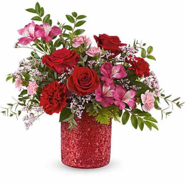 Red roses and pink flowers in a glittery red vase