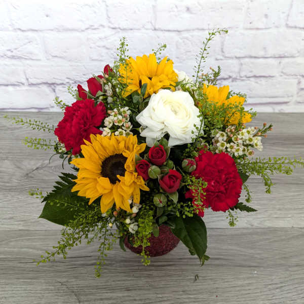 Bouquet of sunflowers, red carnations, white roses, and red spray roses