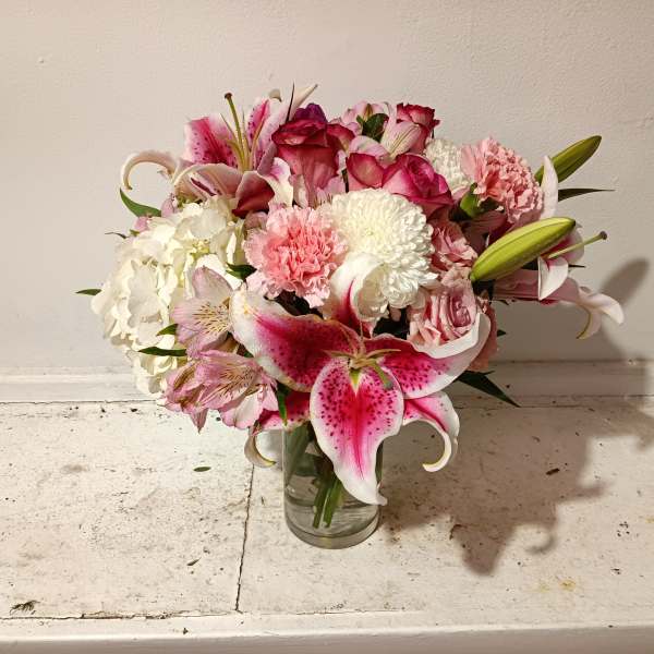Pink and white mixed bouquet in a clear glass vase