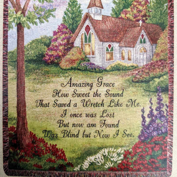 Decorative wall hanging with a church scene and printed hymn text