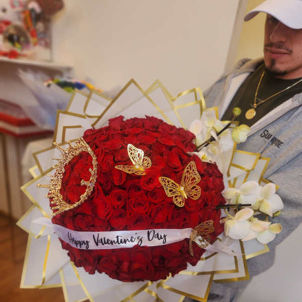 Large bouquet of red roses with white orchids and gold butterfly accents