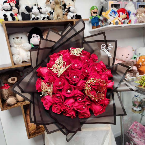 Bouquet of bright red roses wrapped in dark sheer paper with butterfly accents