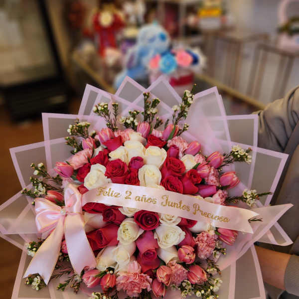 Pink and white rose bouquet with a satin ribbon and pink wrap