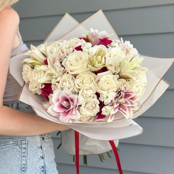 Bouquet of cream and pink flowers wrapped in white paper