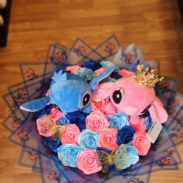 Bouquet of blue and pink roses with two plush characters and butterfly wrap