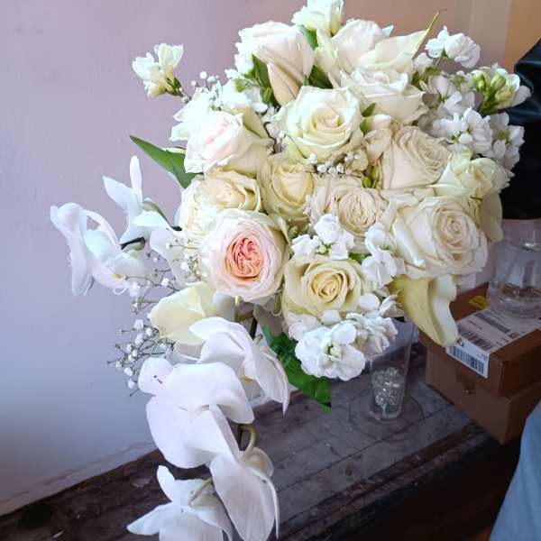 White rose and calla lily bouquet with pale peach accents