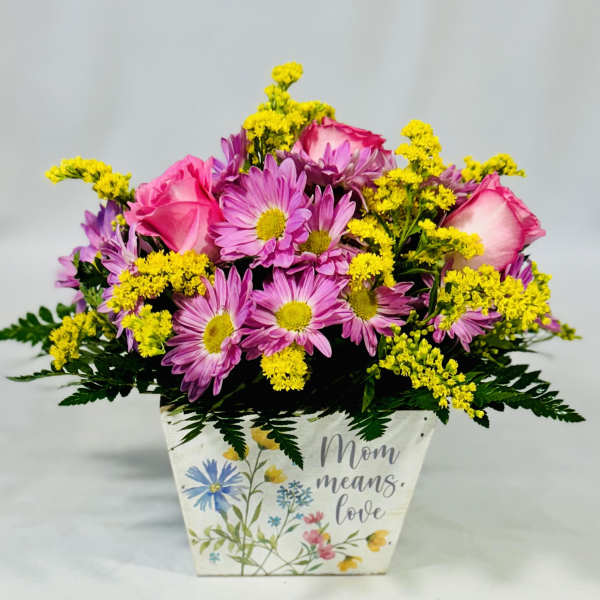 Pink roses and purple daisies in a decorative Mom planter