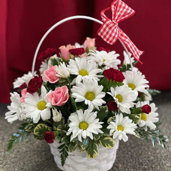 Basket of white daisies and pink roses with a red gingham bow