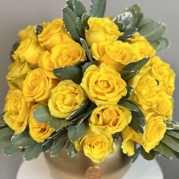 Bouquet of yellow roses in a gold vase